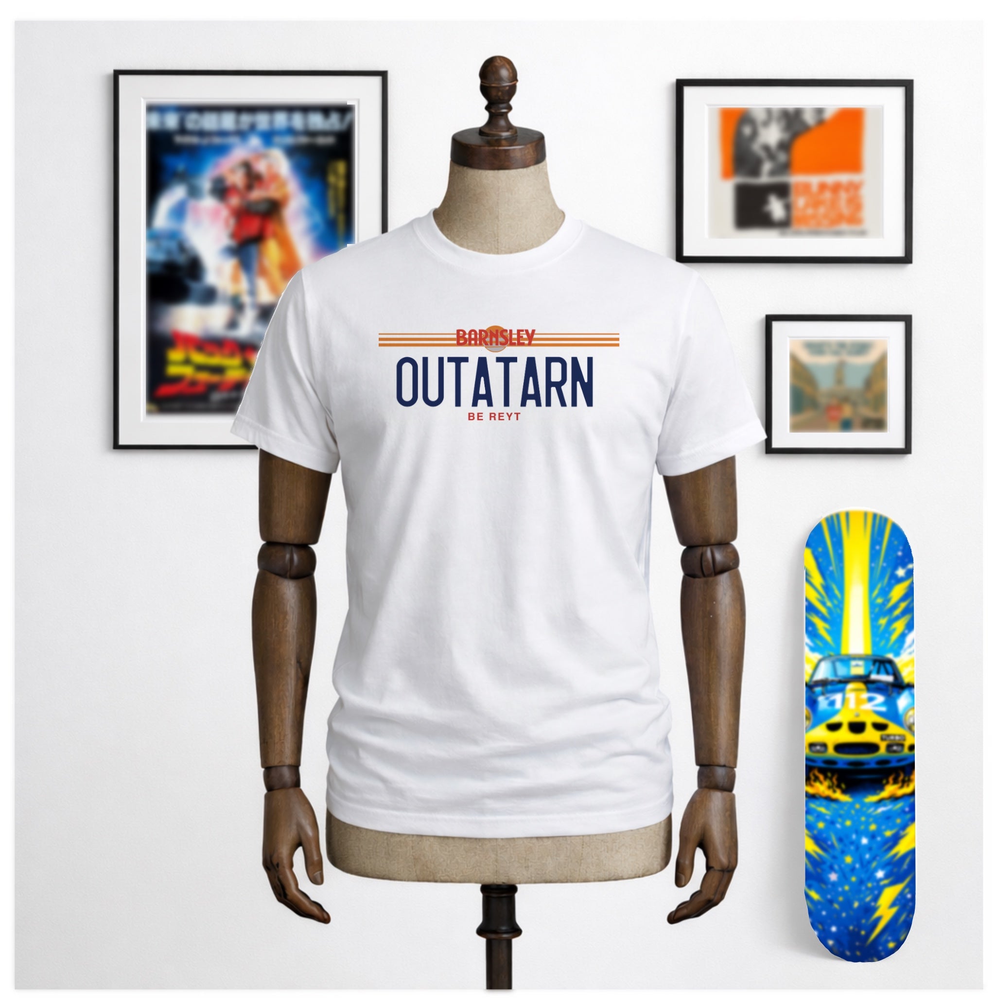 white unisex t shirt with the logo Outatarn in a license plate style. Above the logo is the word Barnsley in Orange text. Below the logo in Orange text is the phrase Be Reyt.